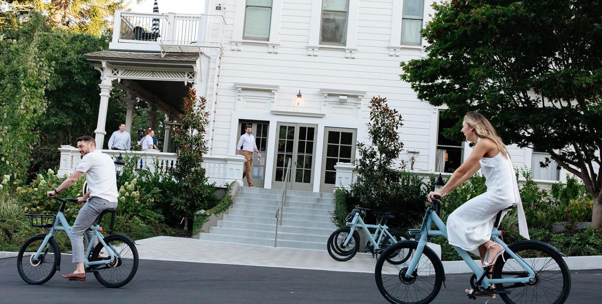 Two people on light blue VanMoof Electric Bikes at The Madrona